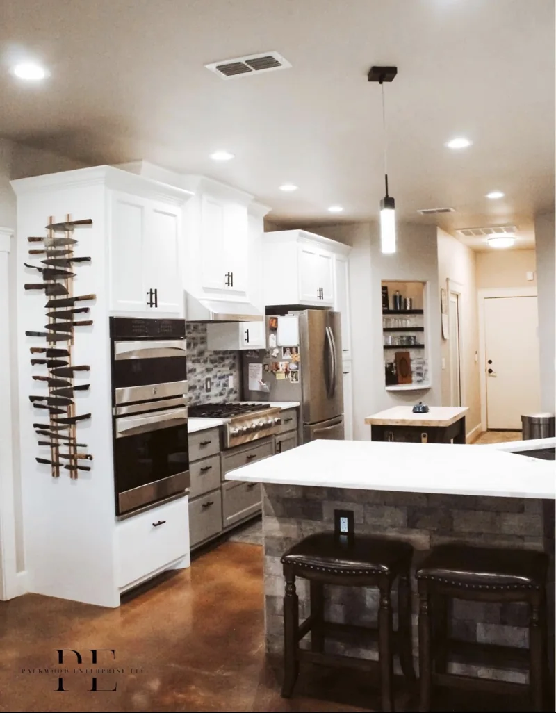 Kitchen with white cabinets, a central island and pendant lighting