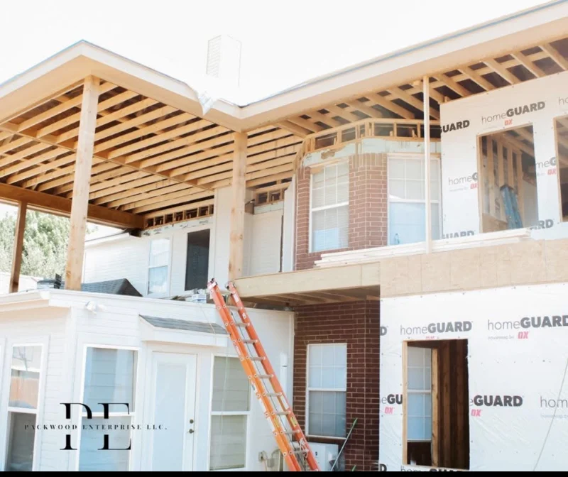 In-progress exterior framing above a two-story home