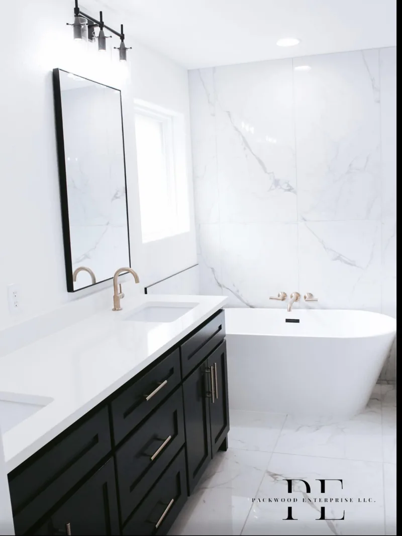 Light bathroom with a dark vanity and freestanding tub